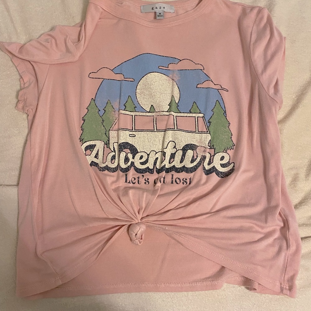 T-shirt, that says “adventure let’s get lost”